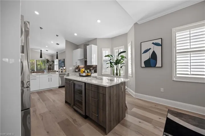 Contrasted center island cabinetry with beverage refrigerator