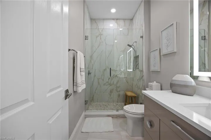 Renovated guest bath with frameless shower door