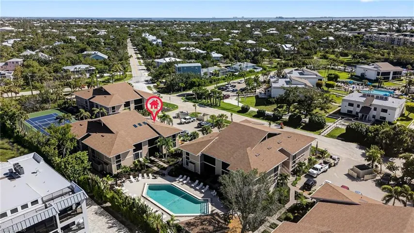 Aerial perspective of suburban area featuring a pool