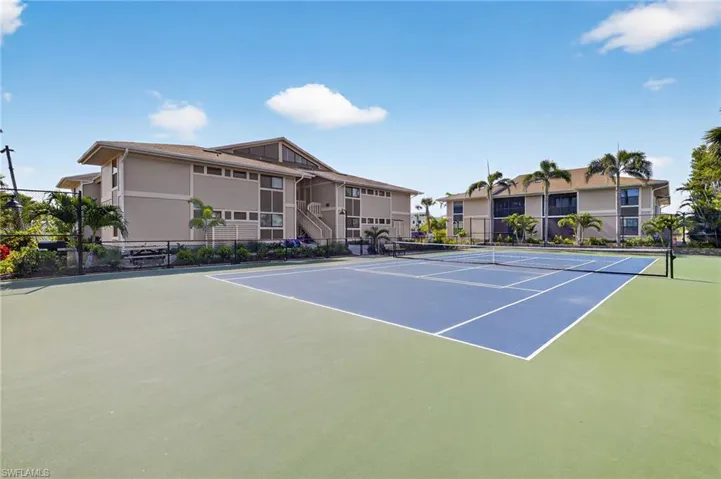 View of tennis court with community basketball court