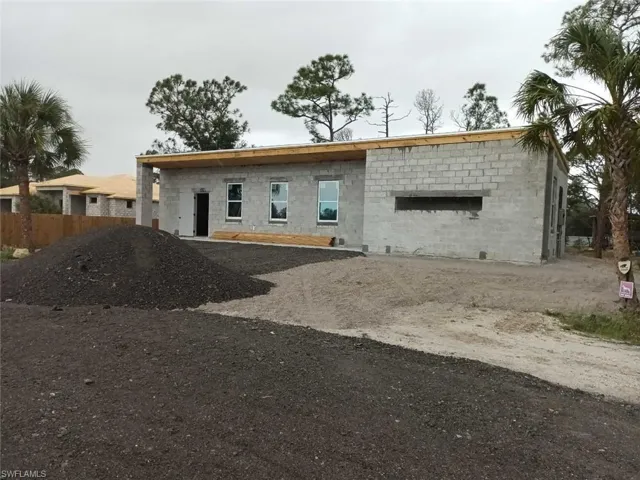 View of front of home featuring concrete block siding