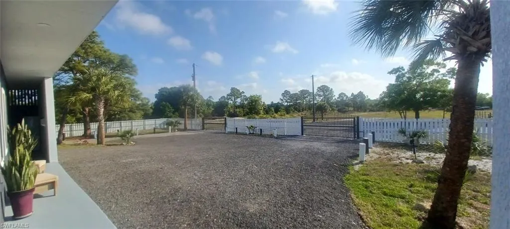 View of yard with fence and a gate