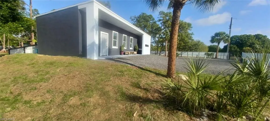 View of yard featuring a patio area, driveway, and fence
