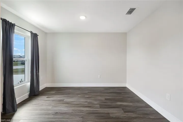 Spare room featuring dark hardwood / wood-style flooring