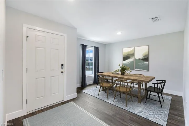 Dining room with dark wood-type flooring