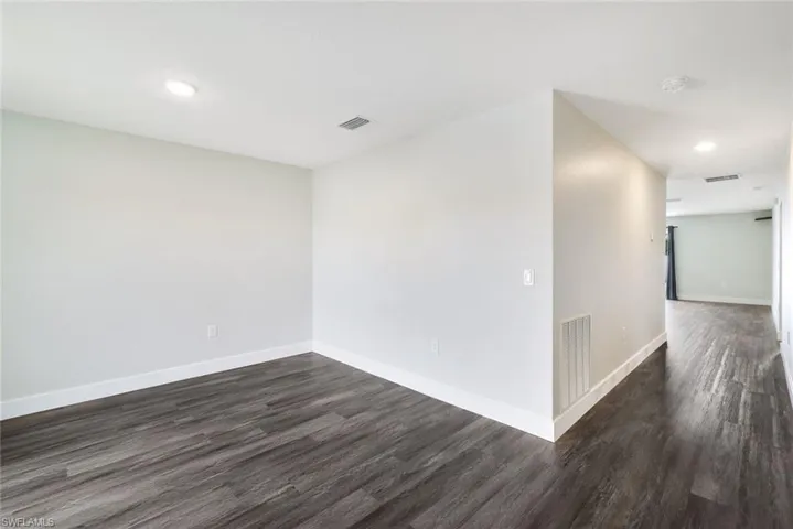 Unfurnished room featuring dark hardwood / wood-style flooring