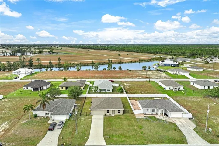 Birds eye view of property with a water view