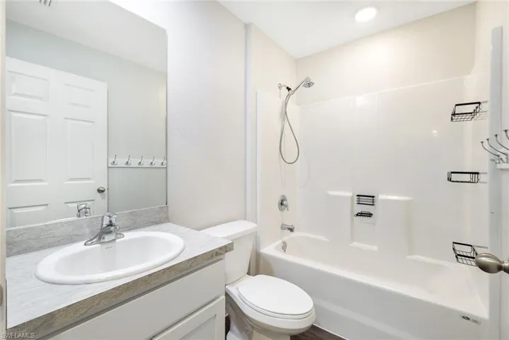 Full bathroom featuring vanity, toilet, and bathing tub / shower combination