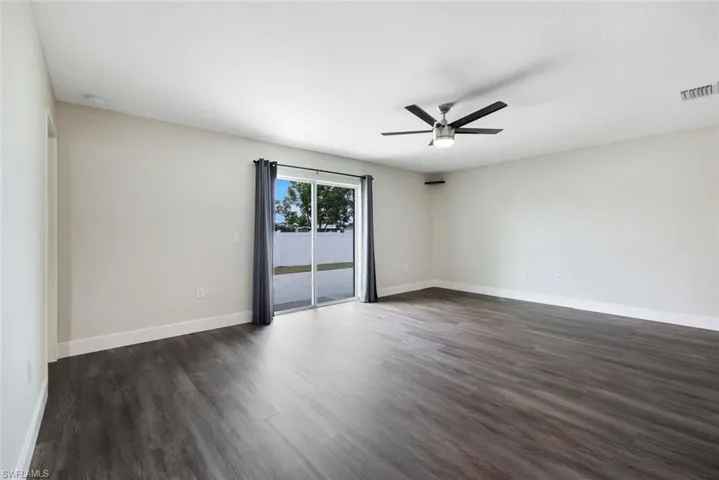 Spare room with ceiling fan and dark hardwood / wood-style flooring