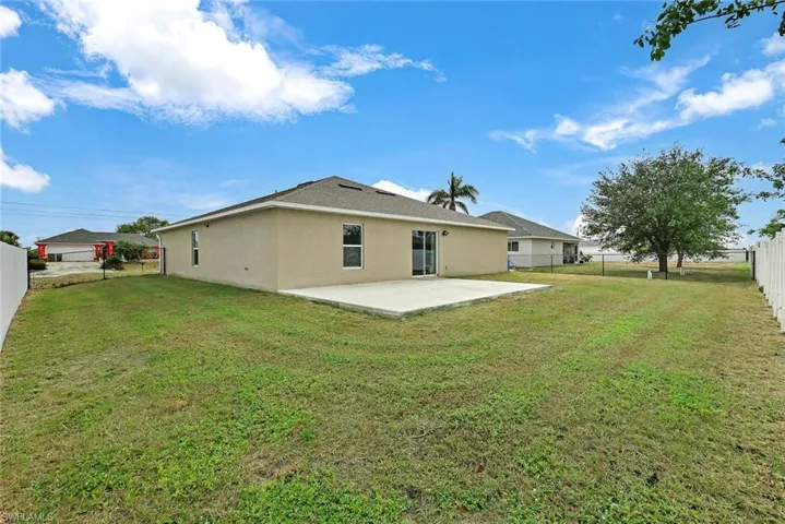 Rear view of property featuring a patio area and a yard