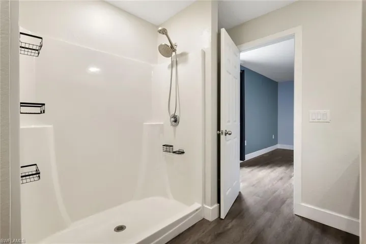 Bathroom featuring a shower and wood-type flooring