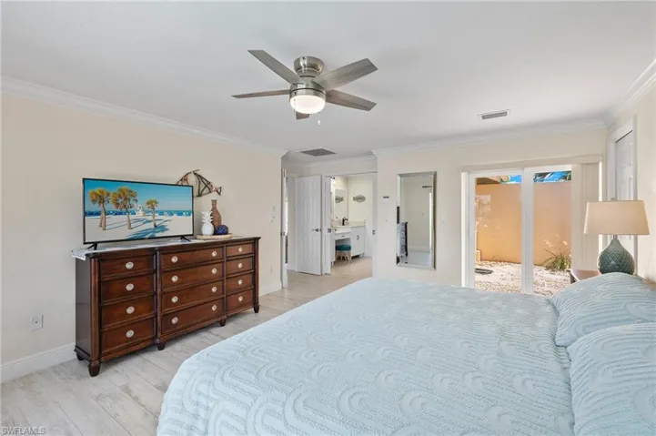 Bedroom featuring crown molding, ceiling fan, access to outside, and light wood-style floors