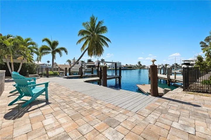 Dock area featuring a water view and boat lift