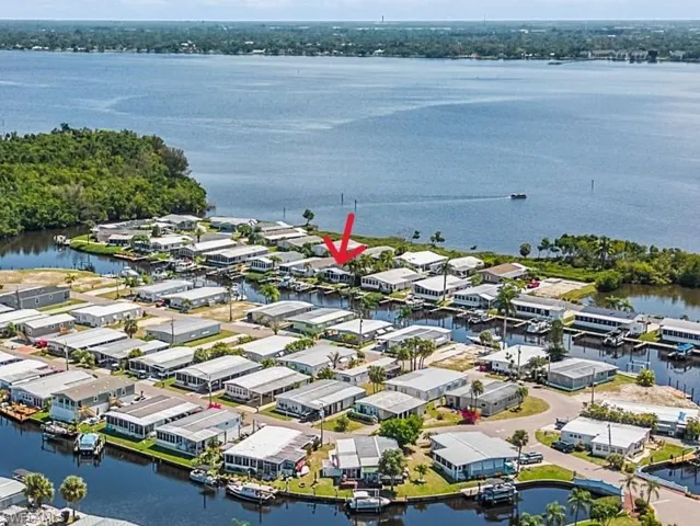 Birds eye view of property with a water view