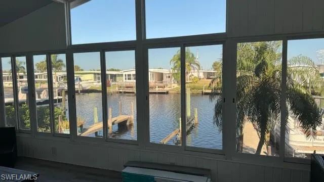 Sunroom / solarium with a water view (boat slip right outside)  Look at the extra top windows to bring in more light