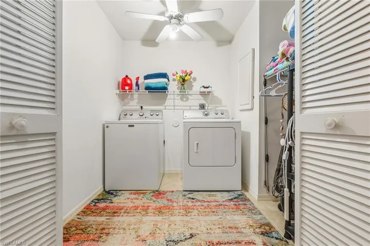 Laundry room with washer and dryer and ceiling fan