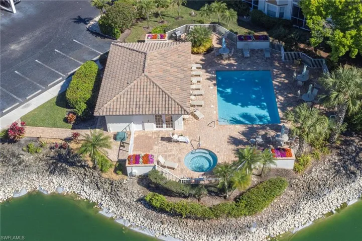 View from above of property with a pool and a large body of water