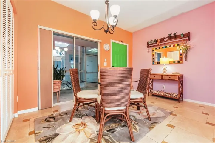 Dining area featuring a chandelier and baseboards