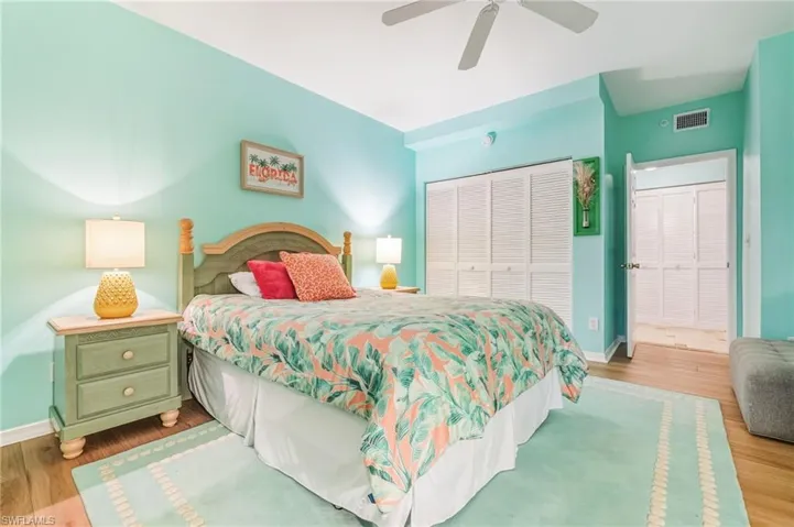 Bedroom with wood finished floors, a closet, and ceiling fan