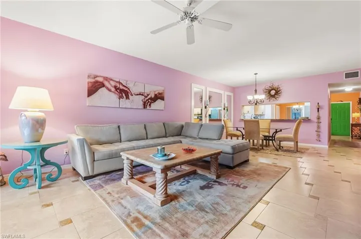 Living room with a ceiling fan and a chandelier