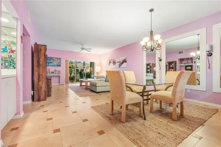 Dining area featuring a chandelier and a ceiling fan