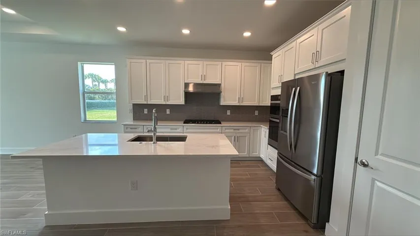 Gourmet kitchen with quartz countertops, soft-close cabinetry, and stainless steel appliances