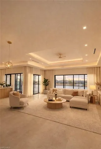 Living room featuring a raised ceiling, plenty of natural light, ceiling fan, and recessed lighting (Rendered photo)