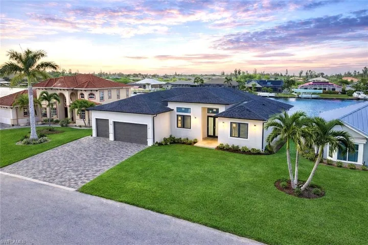 View of front of home with a lawn, decorative driveway, stucco siding, an attached garage, and roof with shingles (Rendered photo)