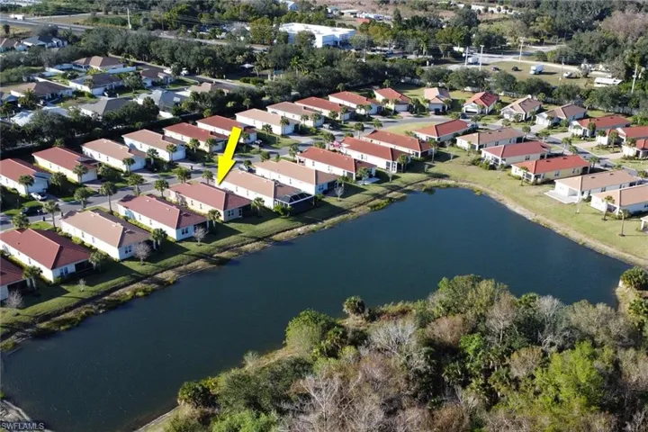 Aerial overview of property's location featuring a nearby body of water and nearby suburban area