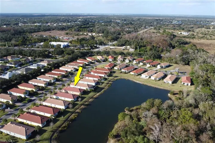 Aerial overview of property's location with a large body of water and nearby suburban area
