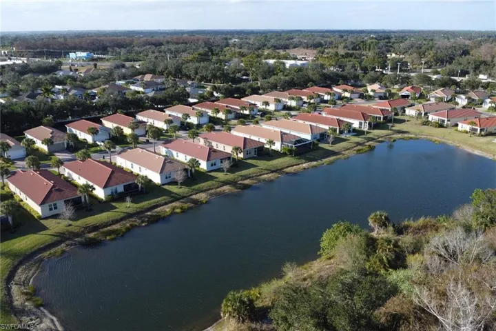 View of property location featuring a large body of water and nearby suburban area