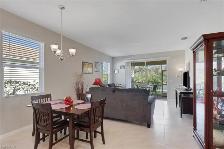 Dining area featuring light tile patterned floors and a chandelier