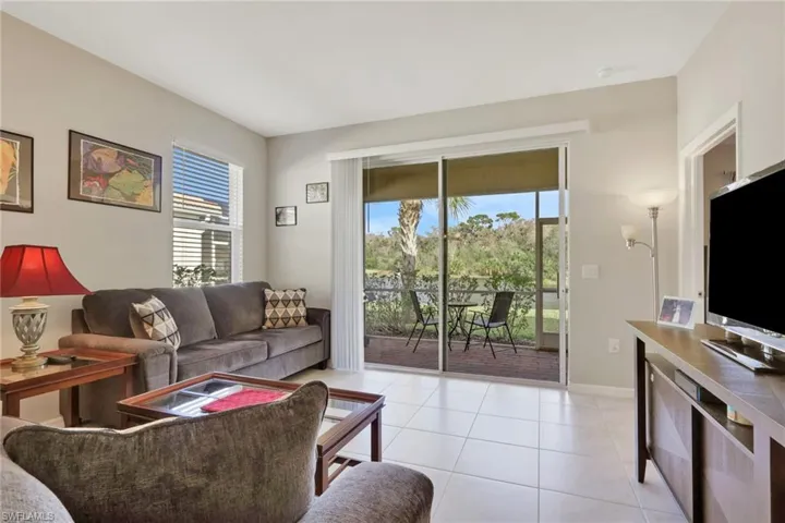 Living area with light tile patterned flooring and baseboards