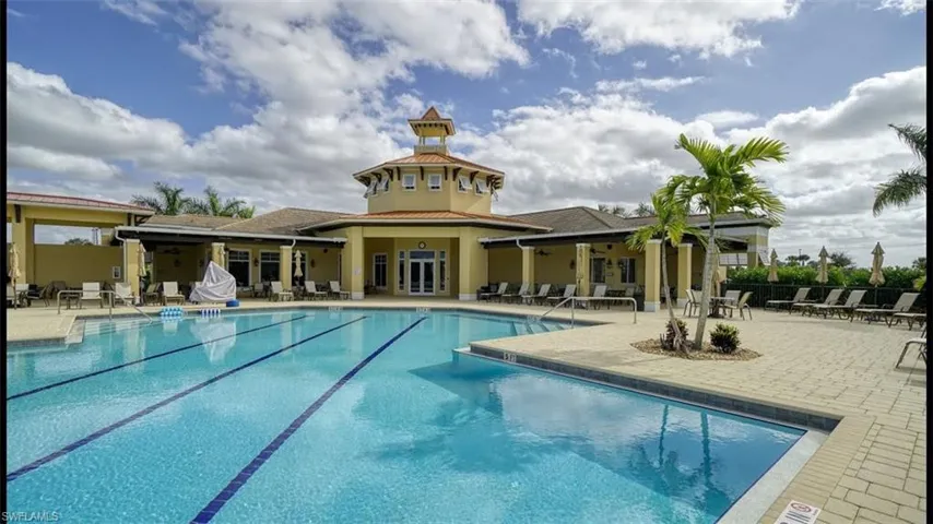 Community pool with a patio area and french doors