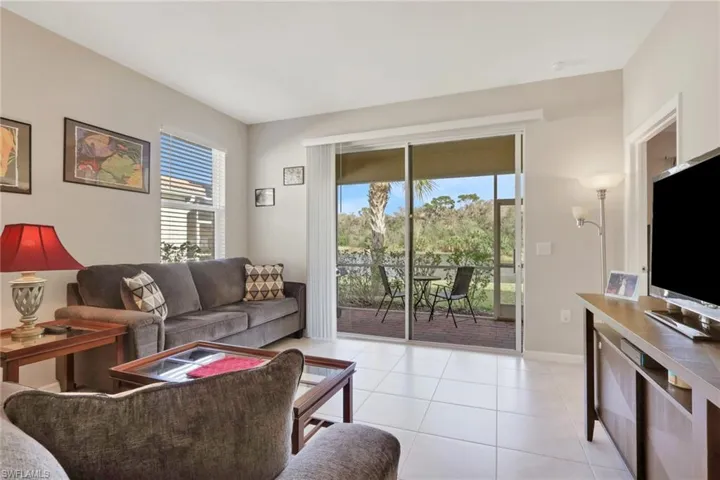 Living room featuring light tile patterned floors and baseboards