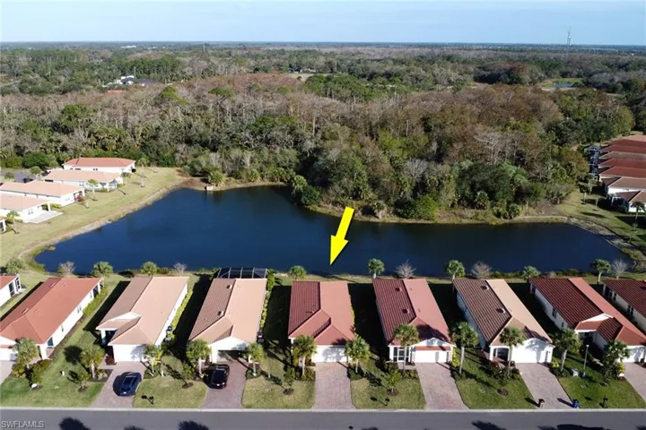 Aerial view of property's location with nearby suburban area and a nearby body of water