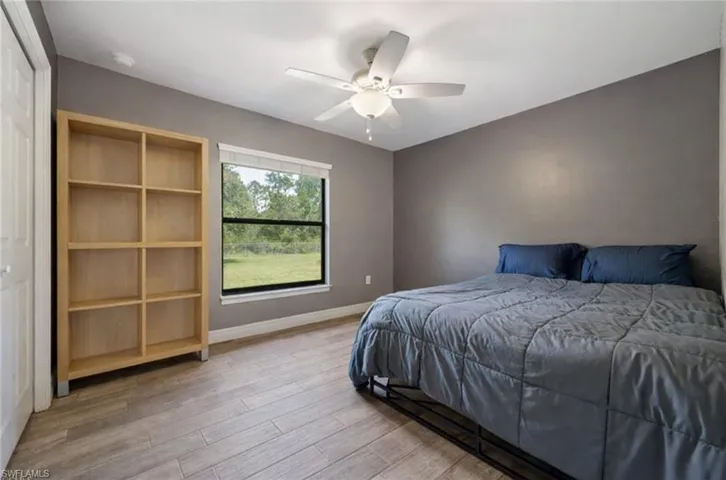 Bedroom featuring wood finished floors and a ceiling fan