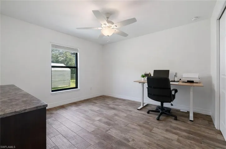 Office space featuring light wood-style floors and ceiling fan