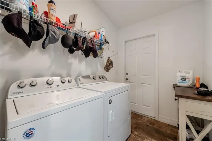 Laundry area featuring dark wood finished floors and separate washer and dryer
