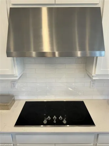Built-in appliances! Separate Stainless hood and classic white textured backsplash.