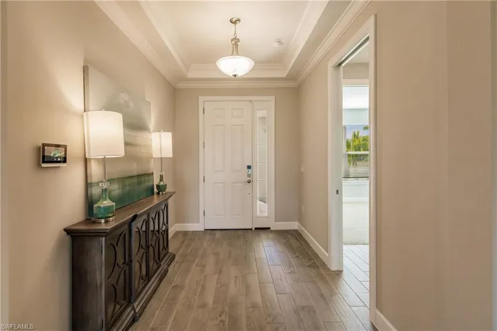 Grand entry foyer with recessed ceilings and two levels of crown moldings.