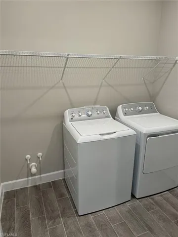 The laundry is a separate room and you don't have to walk through it to get to the garage.  There is already plumbing for a laundry sink.