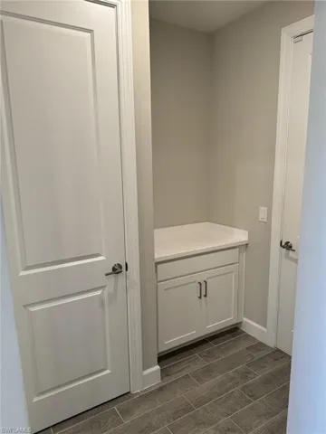 There is a nice hall/mud room with cabinets and a closet leading to the garage.