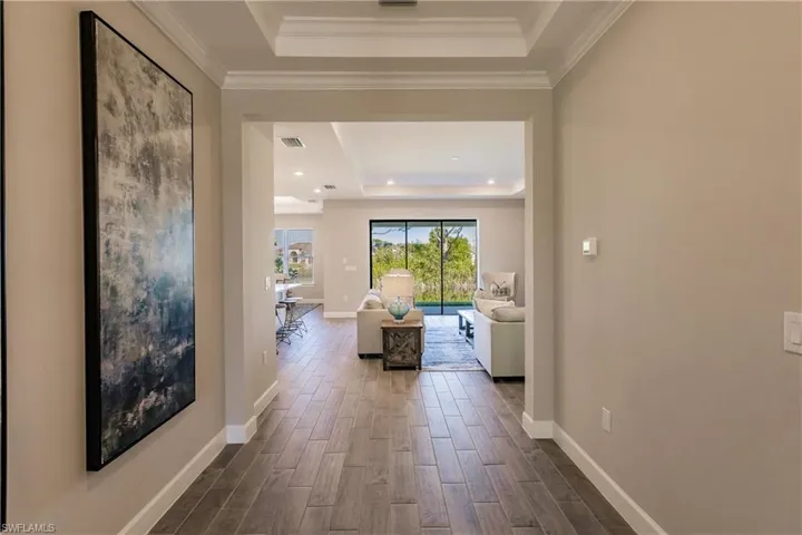 The grand entry foyer allows you to see straight through the home to the water view.