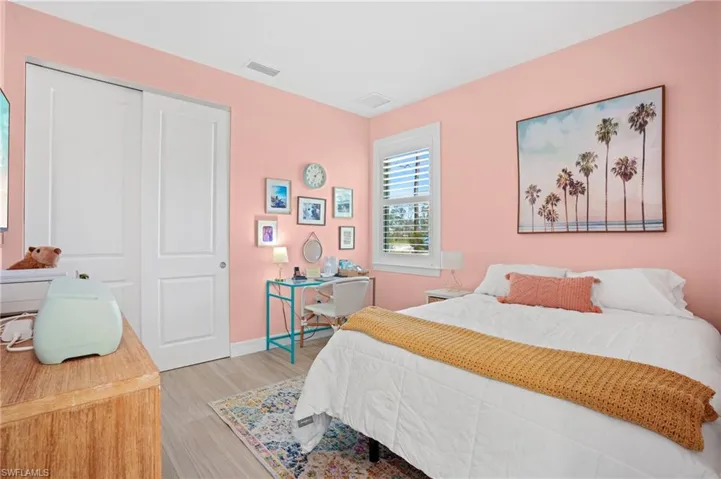 Bedroom featuring light wood-style floors, a closet, visible vents, and baseboards