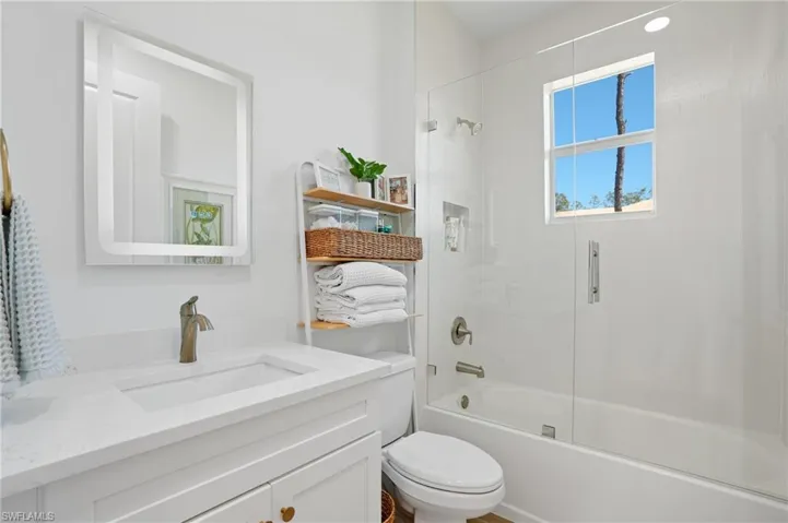 Full bath featuring shower / bathing tub combination, vanity, and toilet