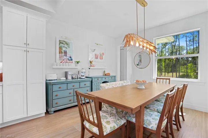 Dining area with light wood finished floors and baseboards