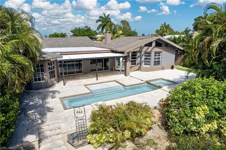 The property features a large patio area with a swimming pool and an integrated spa
