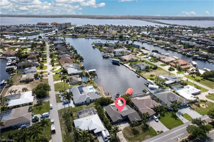 Aerial view showcasing the property's waterfront location, complete with a private dock