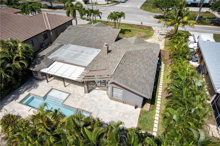 This property features a swimming pool with steps, surrounded by a paved patio area